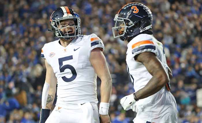 Virginia quarterback Brennan Armstrong celebrates with wide receiver Dontayvion Wicks.